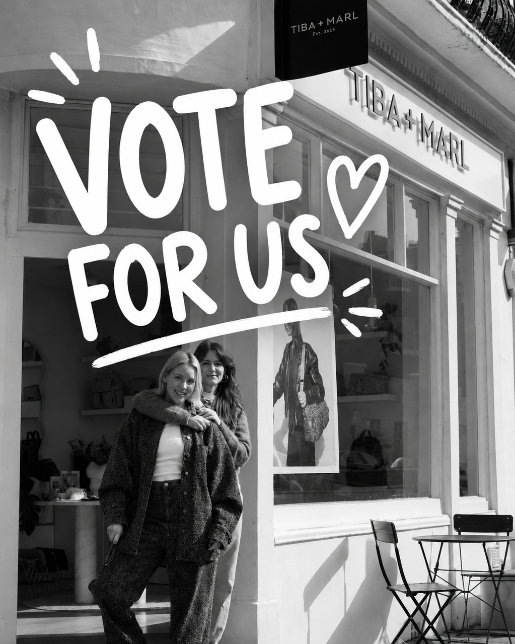 Two women standing outside a store with 'Vote For Us' text overlay